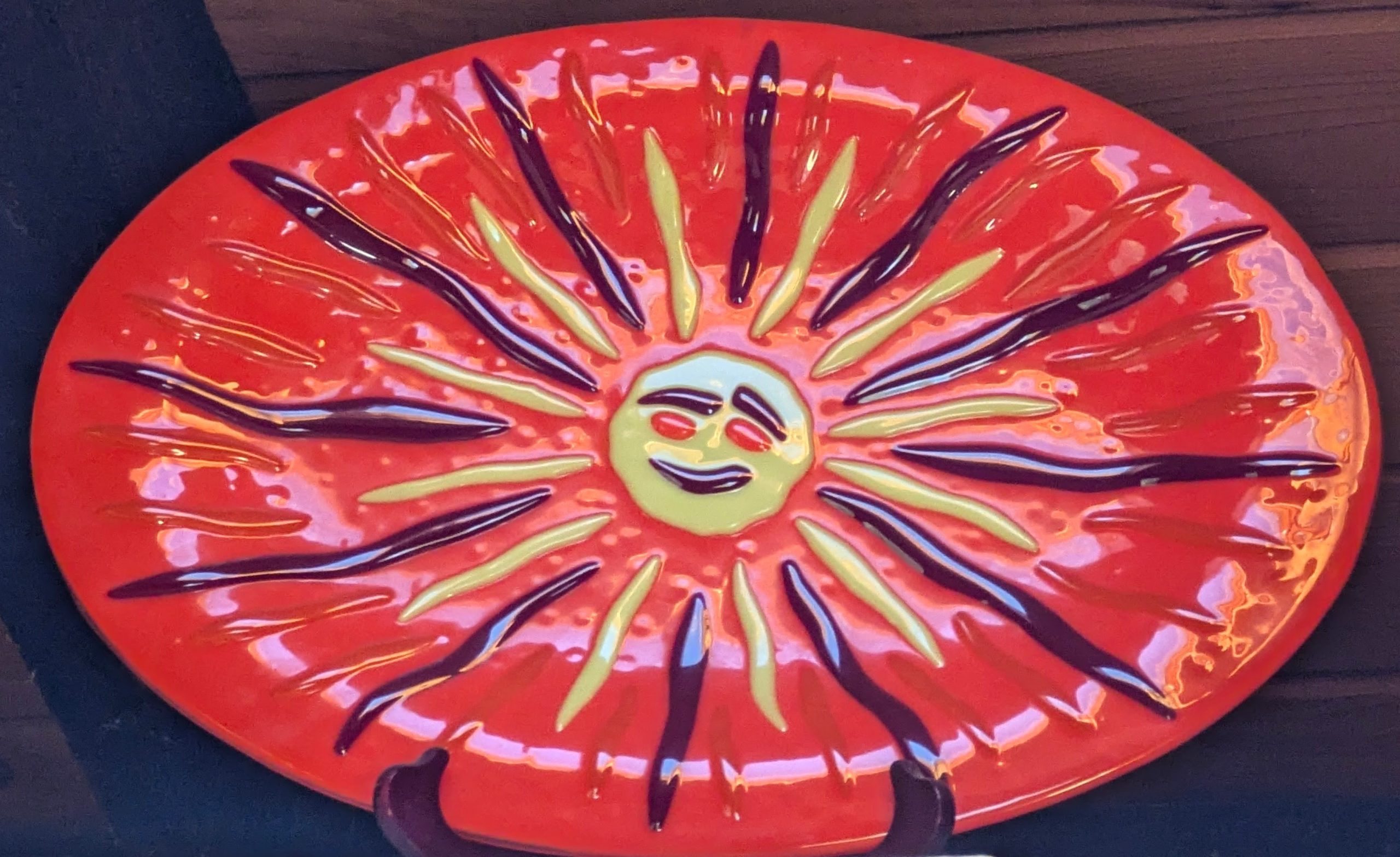 Fused Glass Orange Platter with smiling sun face.